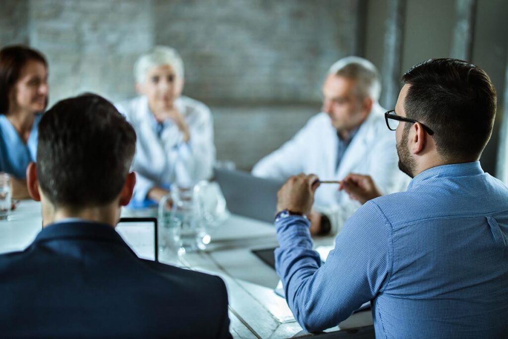 Pharmacists sitting around a table for a quarterly review