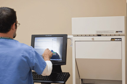 Healthcare worker using a medical station touch screen